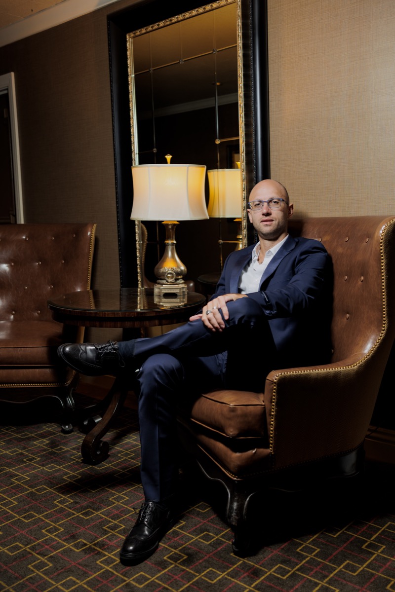 Kirill Kostiuchenko, founder of Fashion Atlas Group, seated in a chair