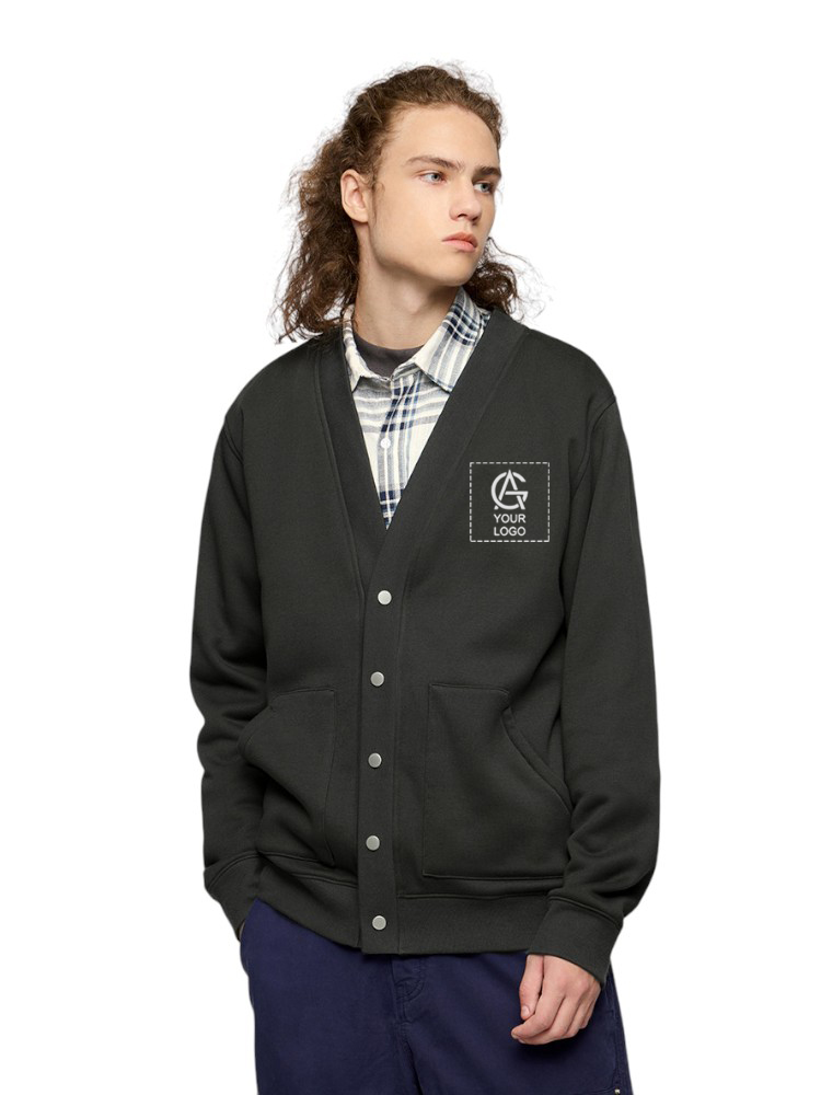 A young person with long curly hair wearing a dark button-up cardigan over a plaid shirt, standing with hands in pockets and looking to the side. The cardigan has a patch that says "YOUR LOGO" on the chest.