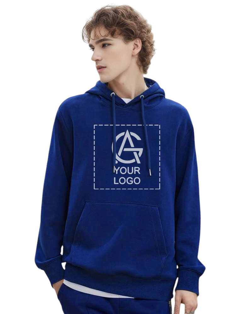 Young person with curly hair wearing a 6W288 royal blue Hoodie featuring a square placeholder with "YOUR LOGO" text and a mock logo on the chest, looking to the side with one hand in their pocket.