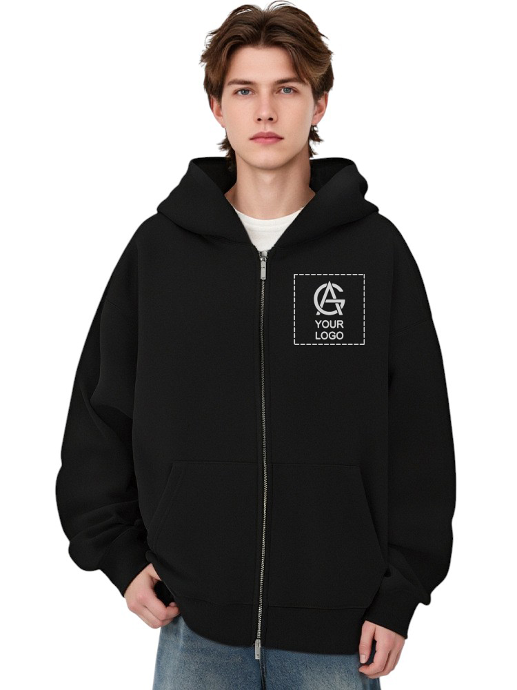 A young person with medium-length brown hair wears a black zip-up hoodie with a white square patch on the chest displaying a generic logo and the text "YOUR LOGO." They are standing against a plain white background.