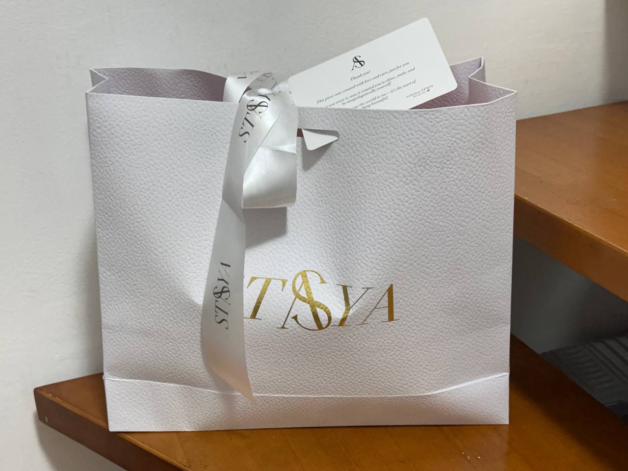 Branded shopping bag with ribbon and customer card