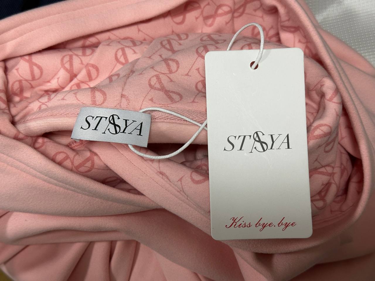 Custom printed hood lining with branded woven label and hangtag