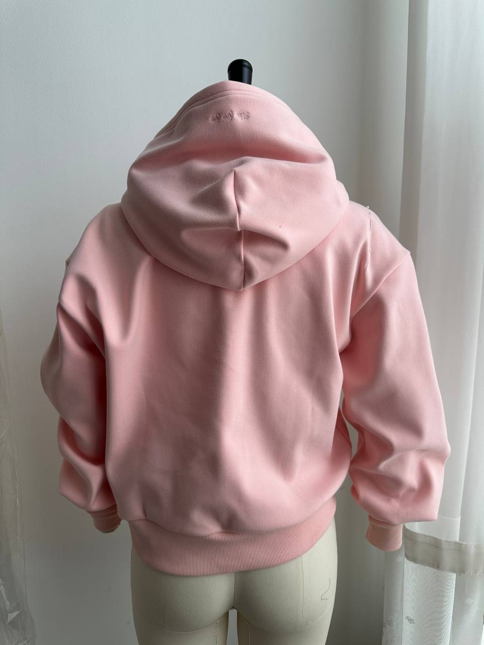 Revised pink hoodie sample with custom sleeves and printed hood lining