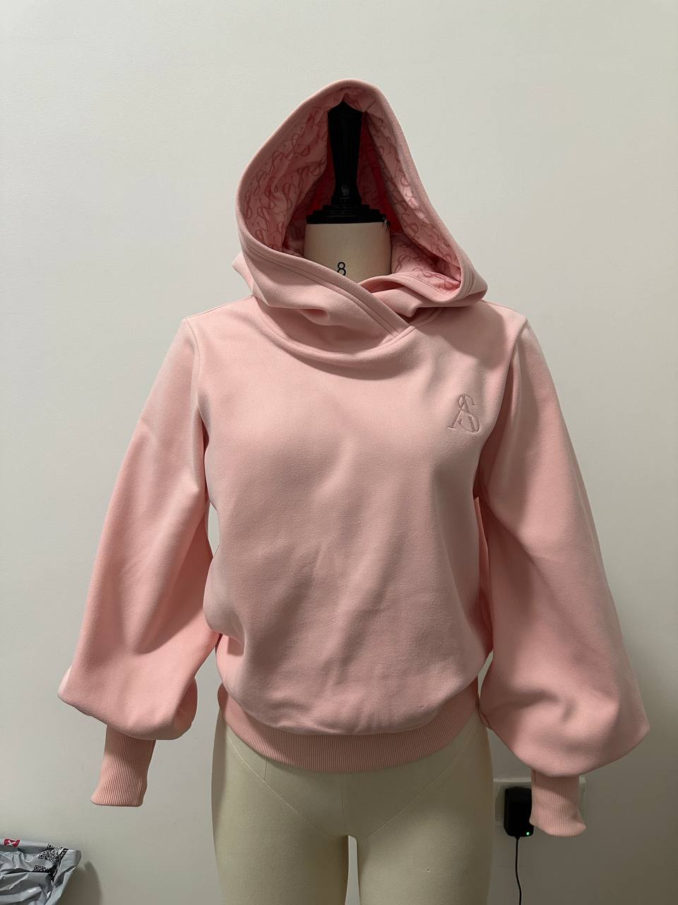 Finished pink custom hoodie with embroidery and printed hood lining