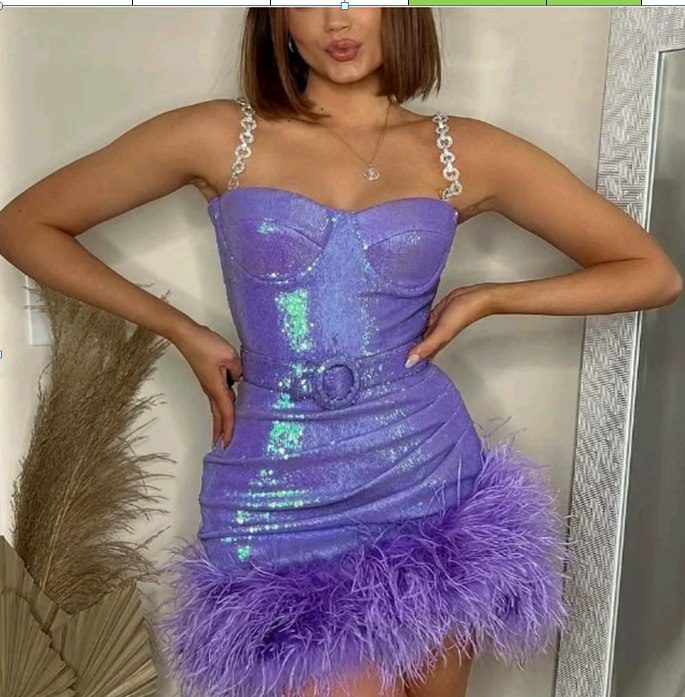 Model wearing a purple sequin mini dress with feather trim
