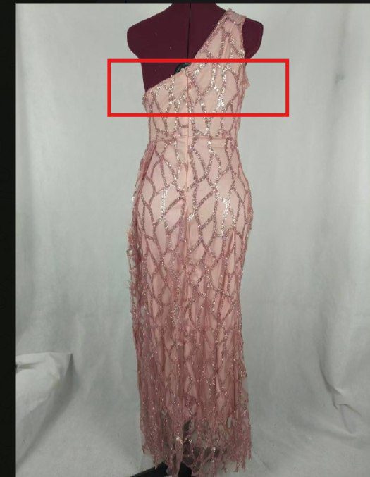 Pink one-shoulder evening dress with a highlighted quality issue near the bodice