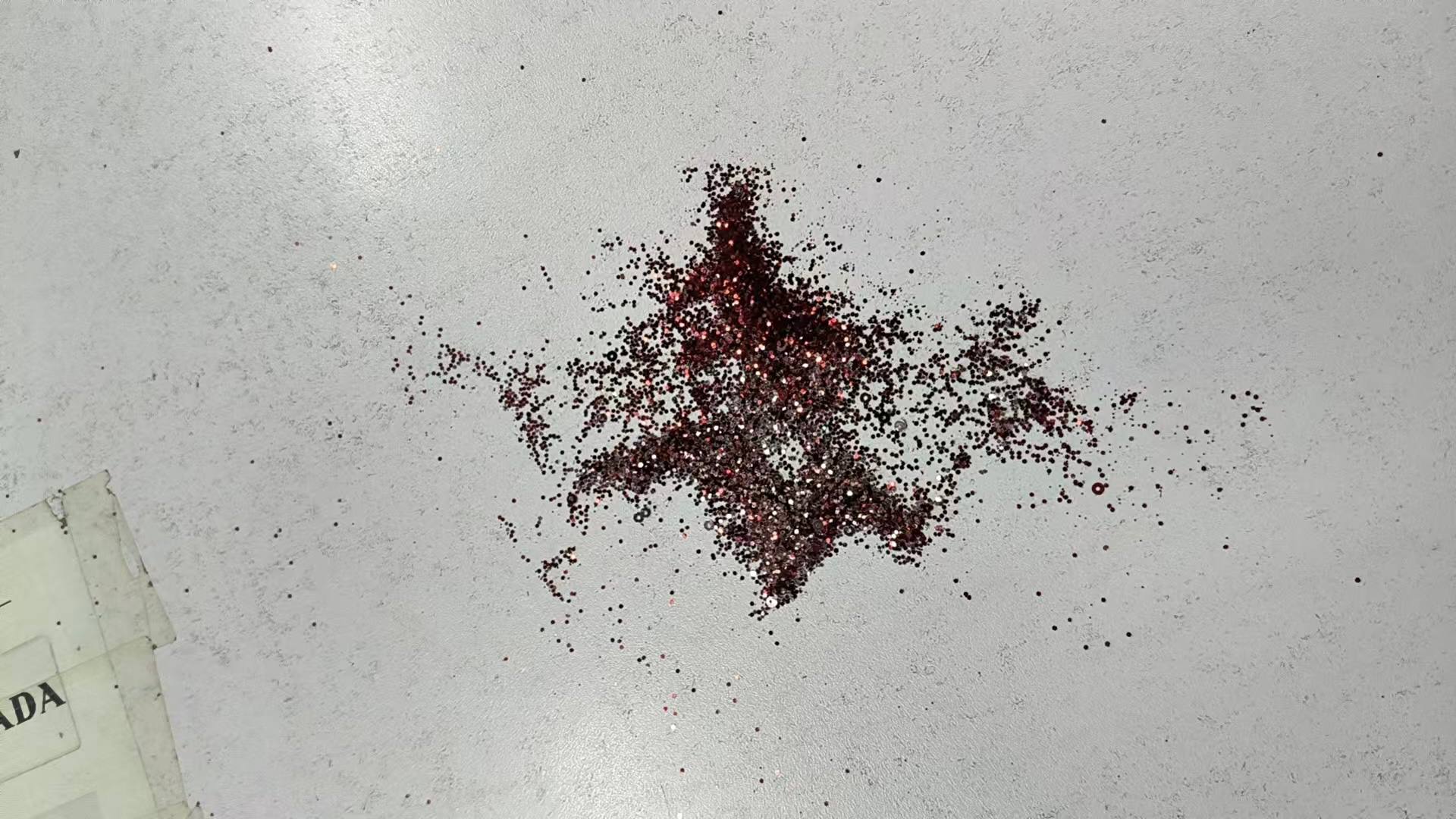 Loose glitter collected during the quality inspection of an evening dress
