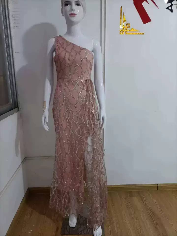 Pink one-shoulder evening dress displayed on a mannequin for inspection