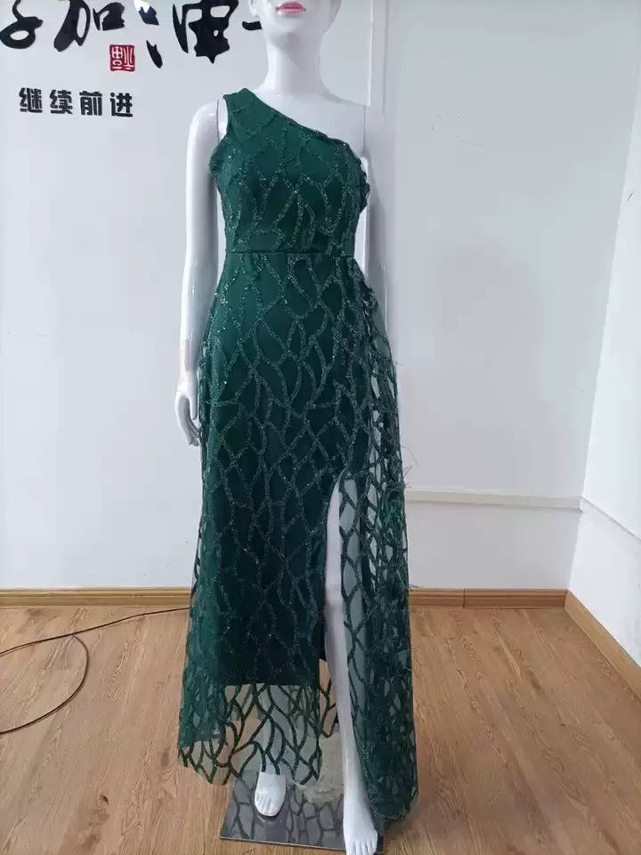 Green one-shoulder evening dress displayed on a mannequin