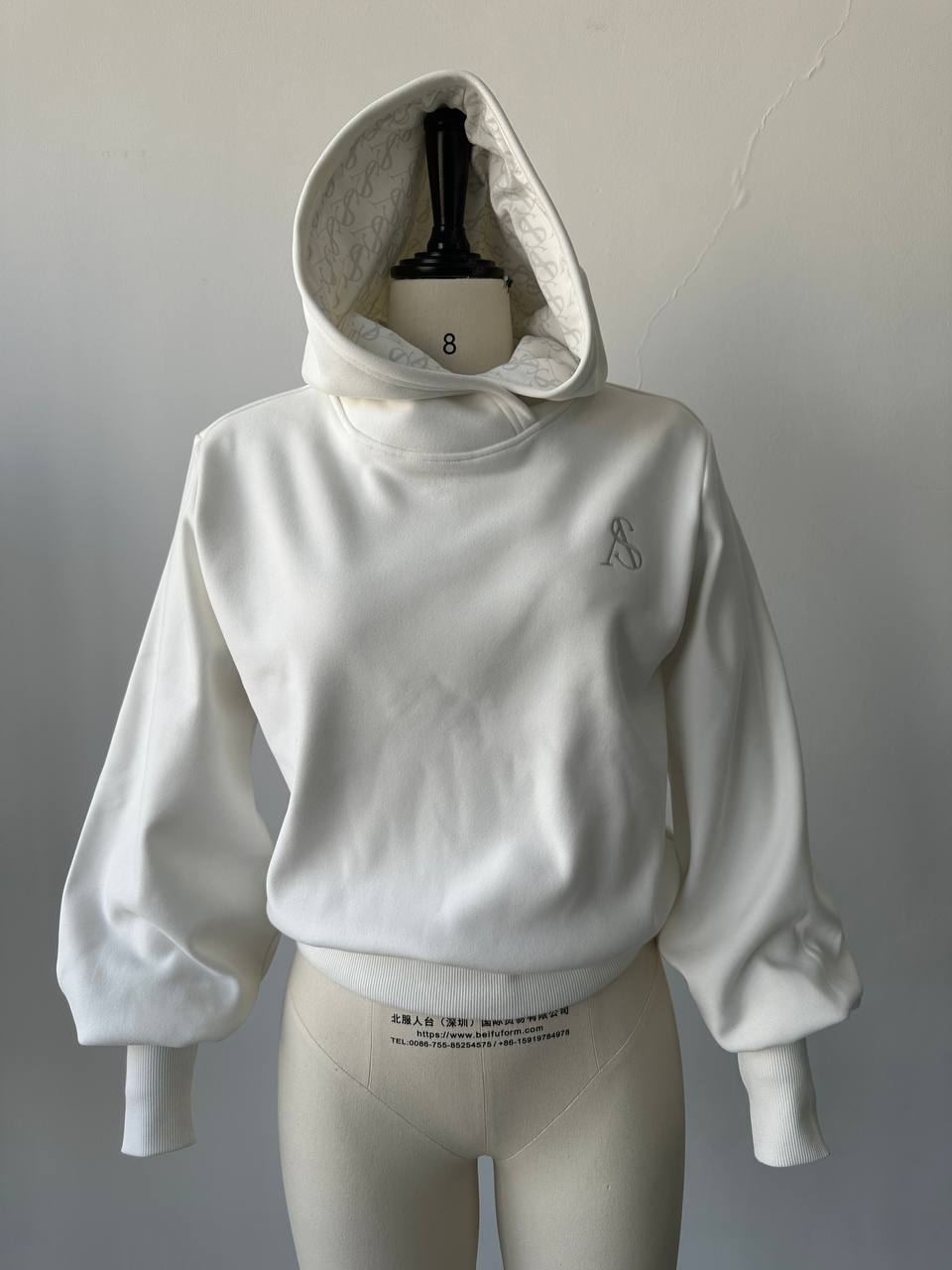 Front view of the cream custom hoodie with embroidery and printed lining