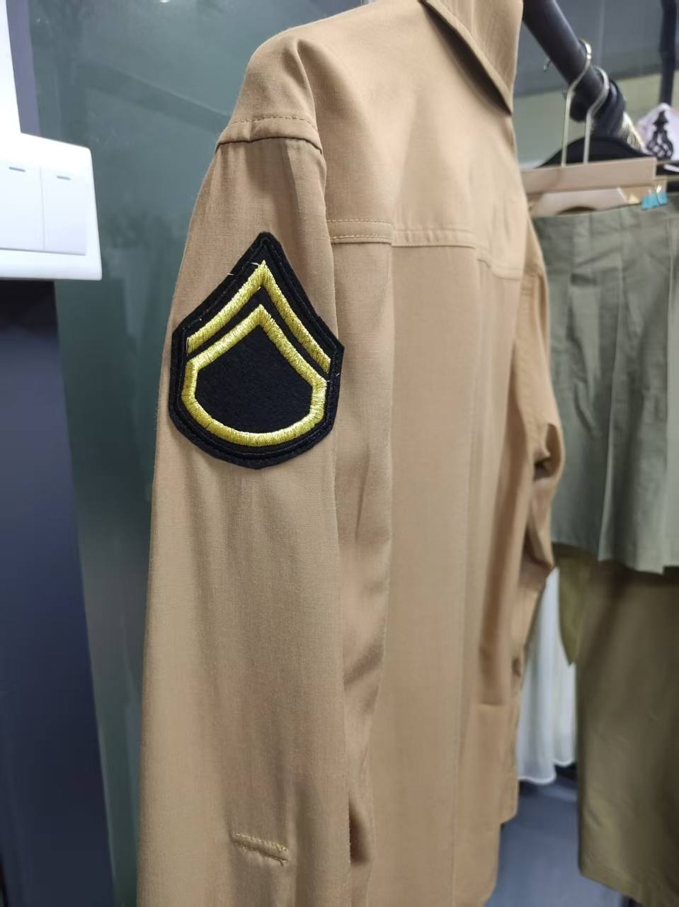 Close-up of embroidered rank patch on custom restaurant uniform shirt sleeve