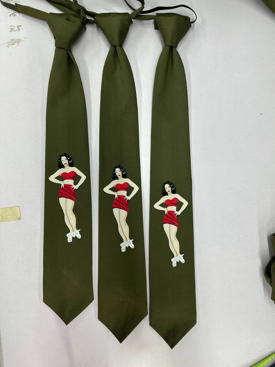 Olive green custom restaurant uniform ties with printed pin-up artwork