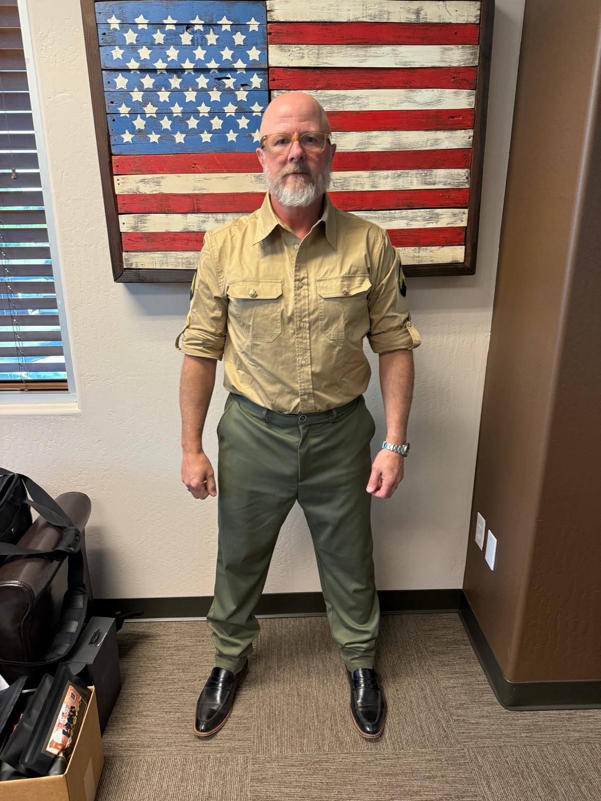Front view of men’s custom restaurant uniform with khaki shirt and olive green trousers