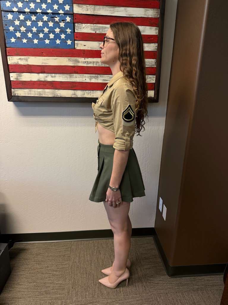 Side view of women’s custom restaurant uniform with cropped shirt, pleated skirt, and rank patch