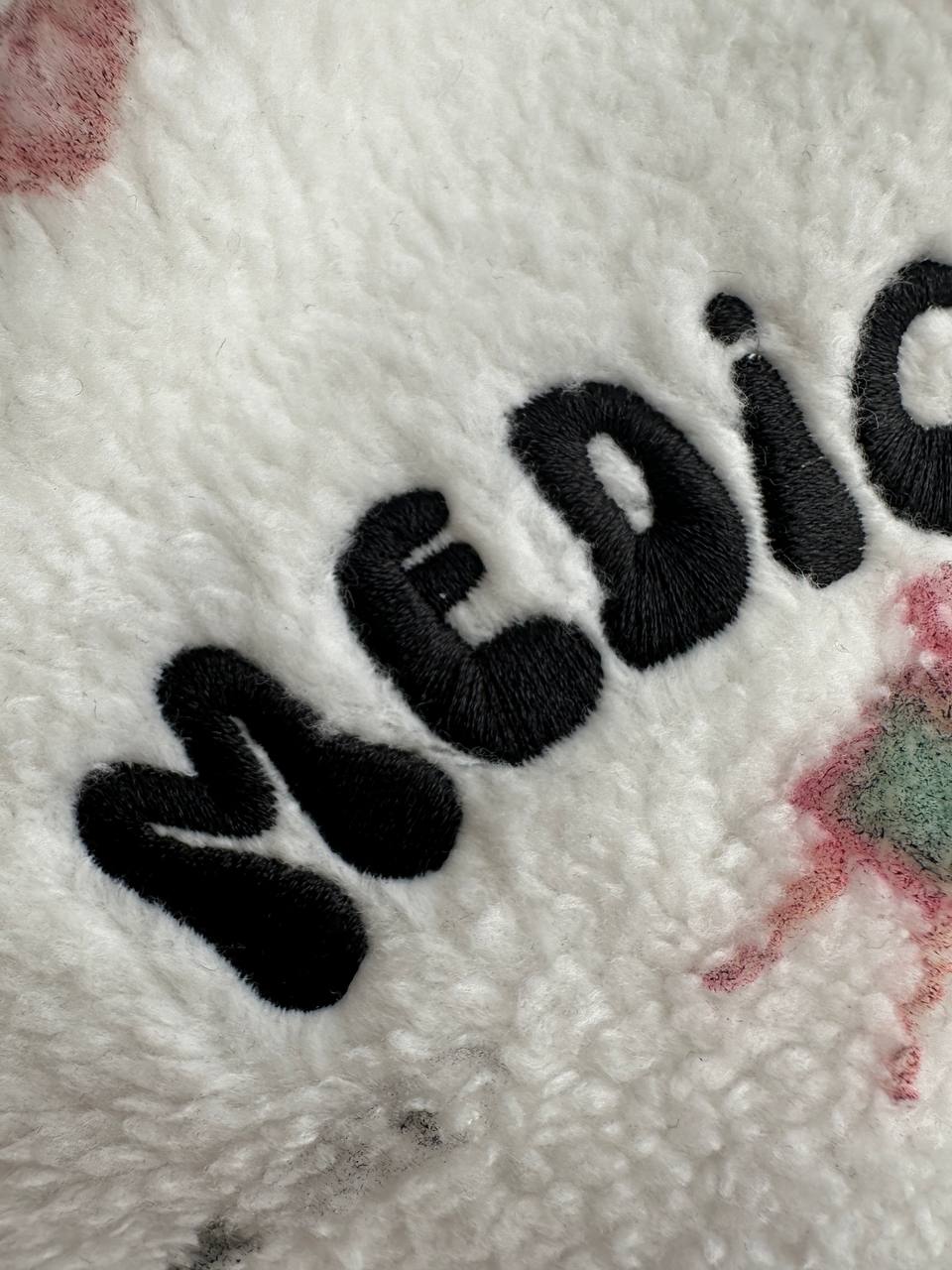 Embroidered logo detail on a custom fleece hoodie