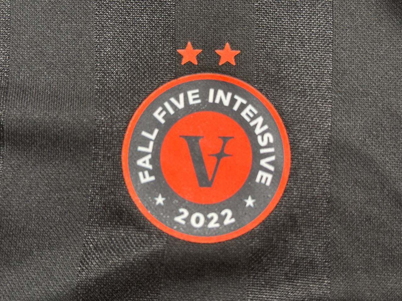 Close-up of red and white branded logo printed on custom jersey